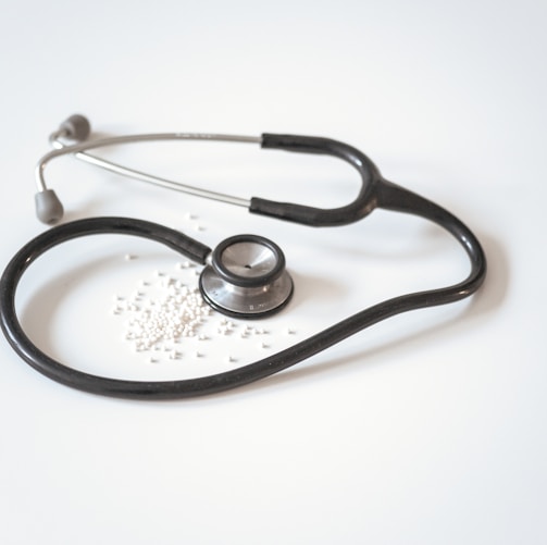 black and silver stethoscope on white surface