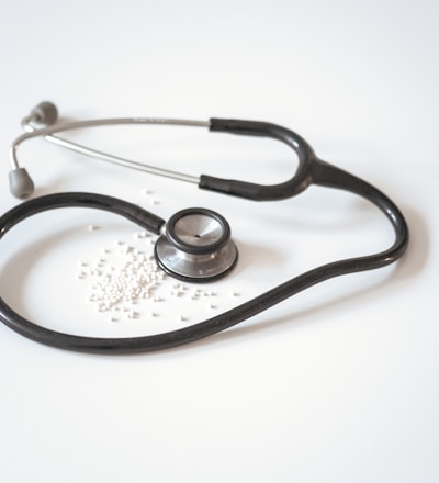 black and silver stethoscope on white surface