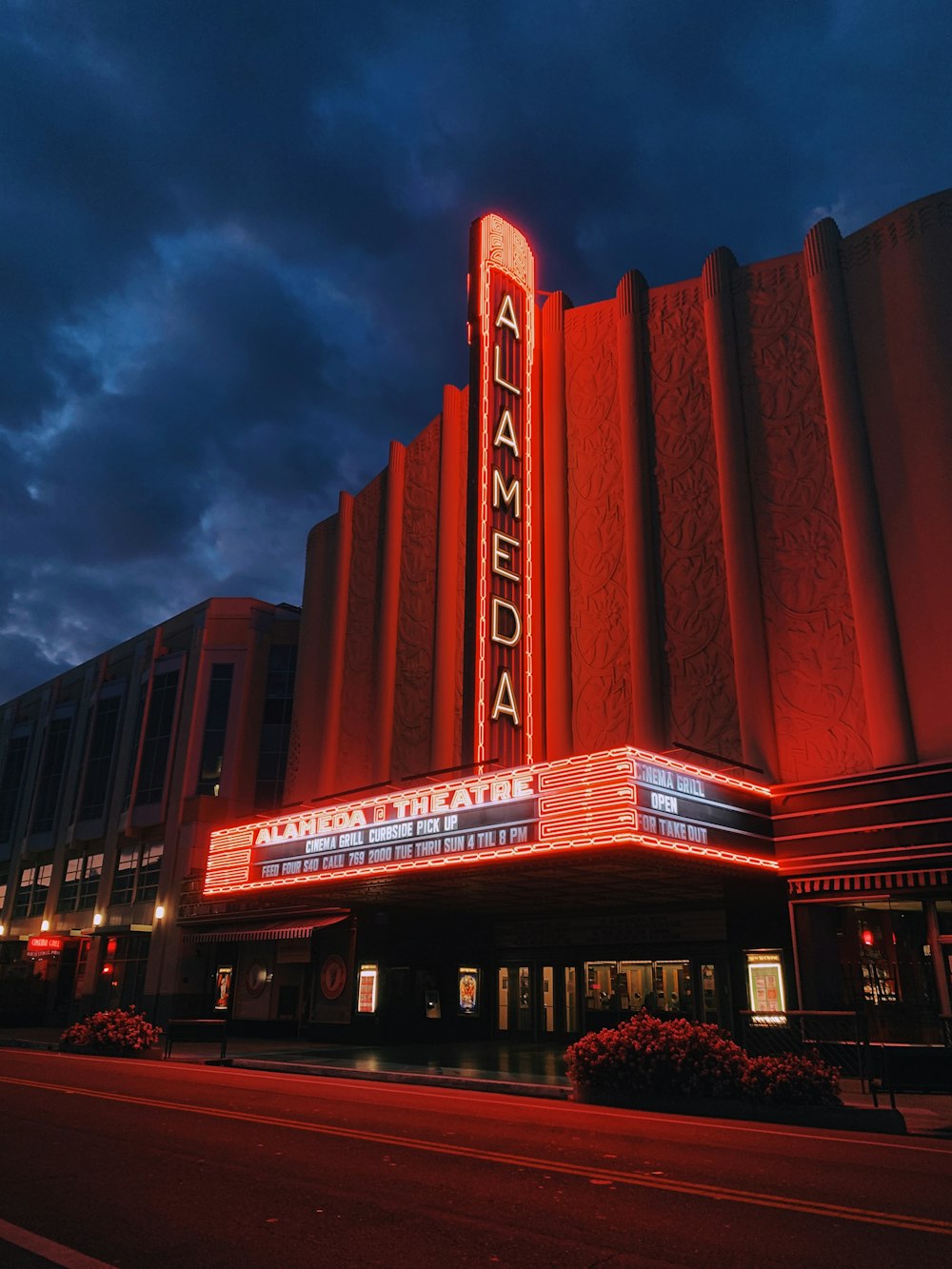 a large theater building with a red light on it's side