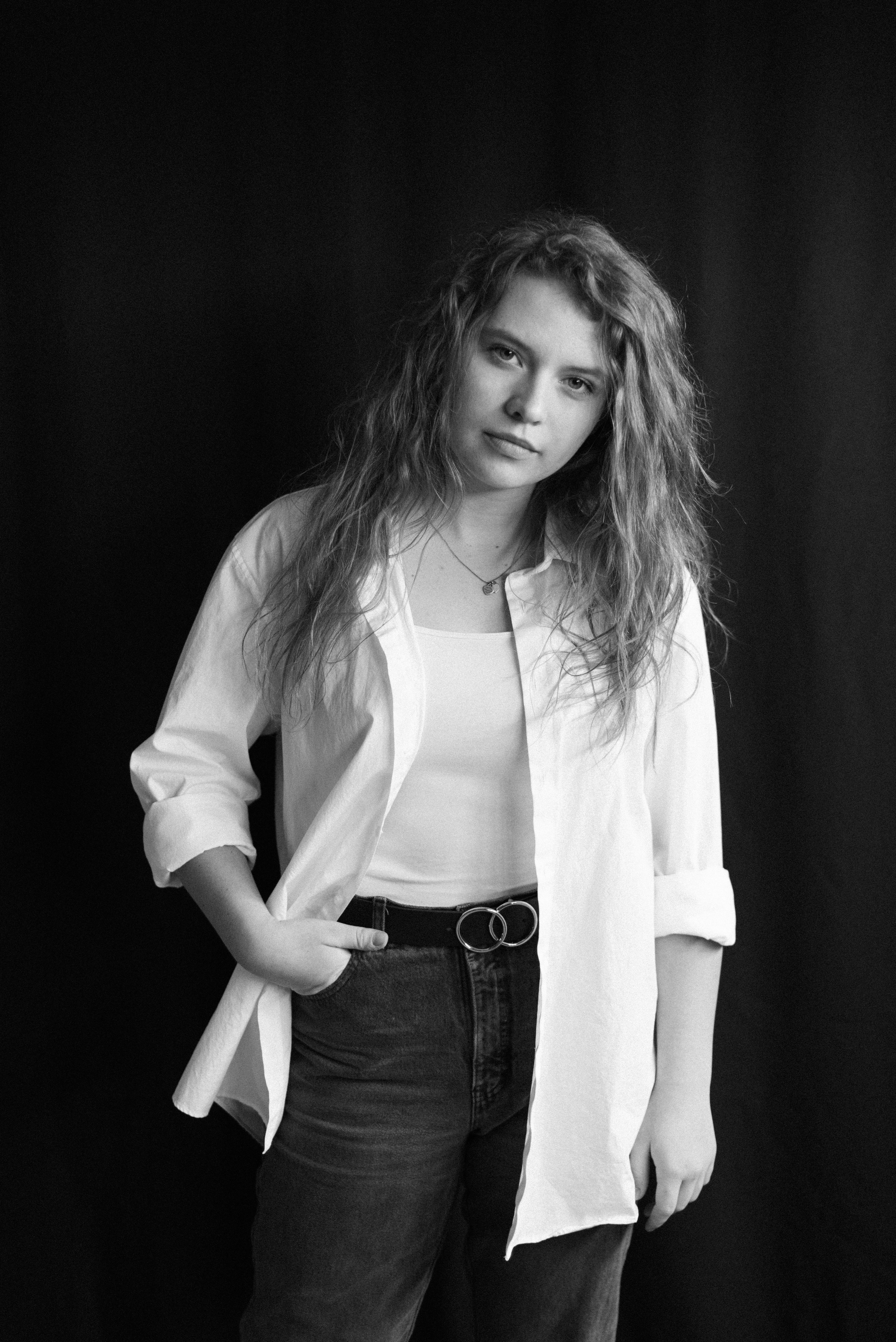woman in white button up long sleeve shirt and black denim jeans