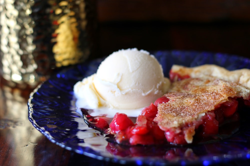 ice cream with strawberry on blue ceramic plate