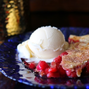 ice cream with strawberry on blue ceramic plate