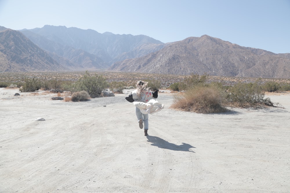 2 women walking on dirt road during daytime