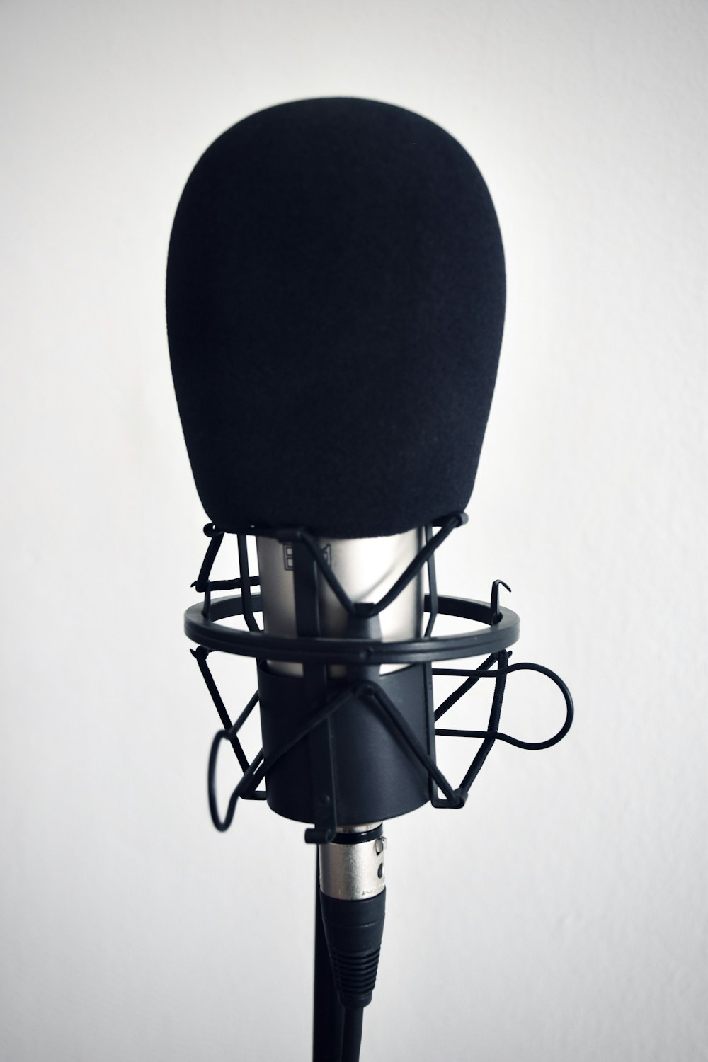 schwarz-silbernes Mikrofon auf schwarzem Ständer