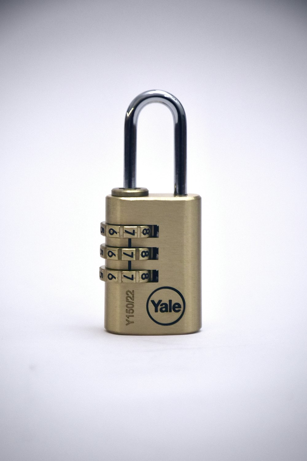 gold padlock on white surface