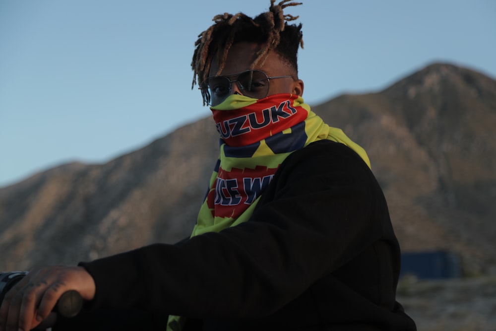 person in yellow and black scarf and black long sleeve shirt