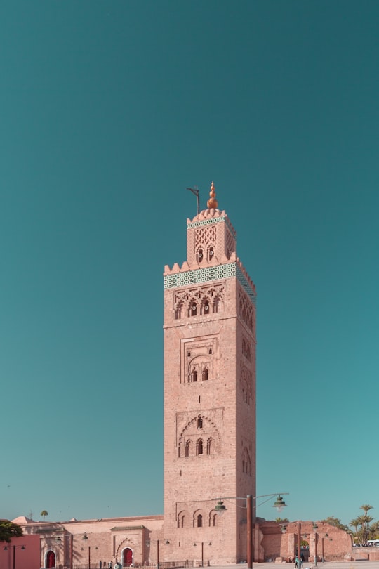 brown concrete tower under blue sky during daytime in Koutoubia Mosque Morocco