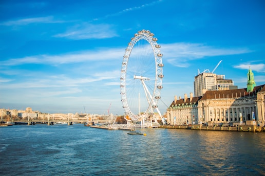 ferris wheel near body of water during daytime