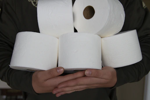 Close-up of neatly stacked white tissue rolls with soft texture visible.