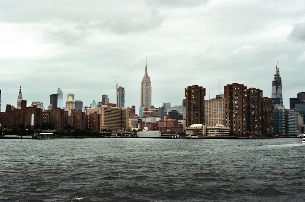 city skyline across body of water during daytime