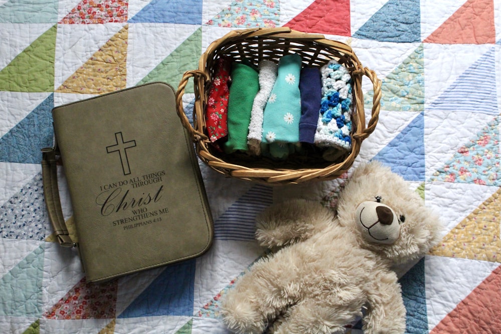 brown teddy bear on white textile