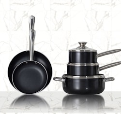 3 stainless steel cooking pots on white ceramic tiles