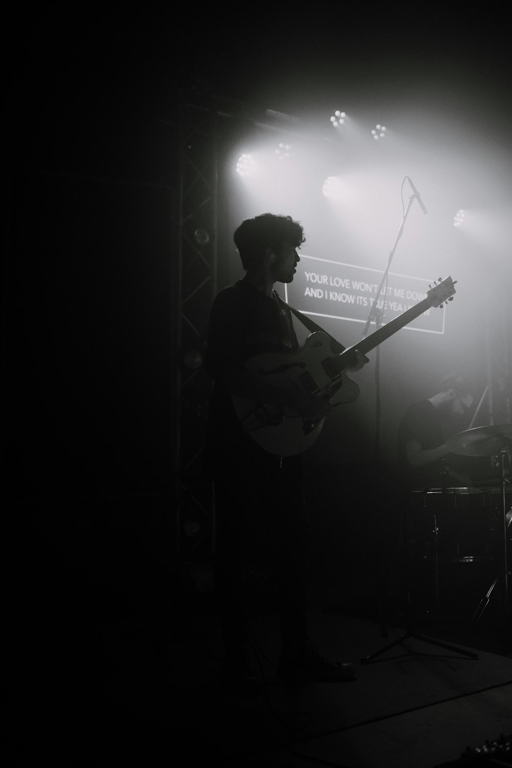 man playing guitar on stage