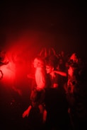 Crowd dancing under dynamic lighting at a techno party.
