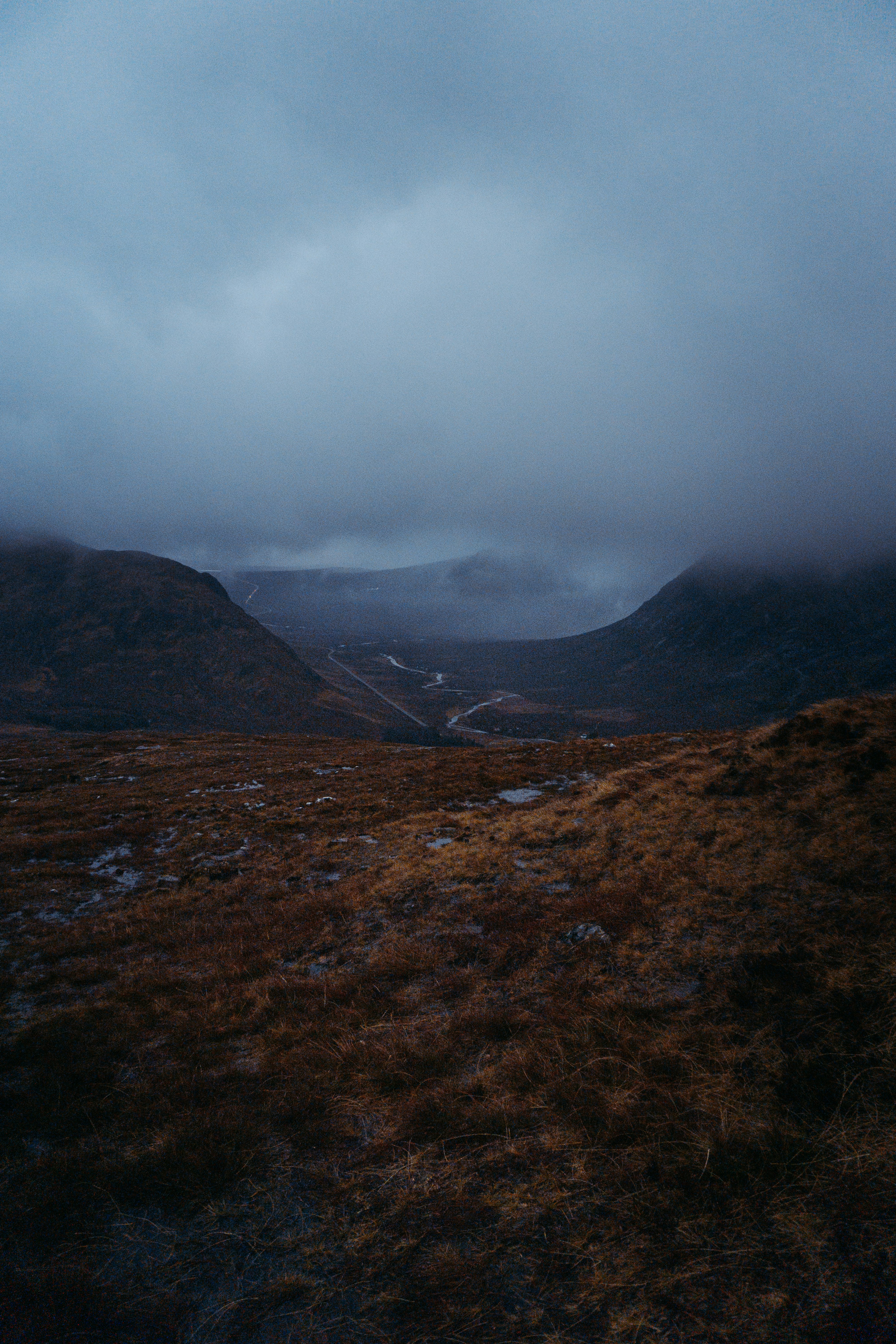 brown and green mountains under white clouds