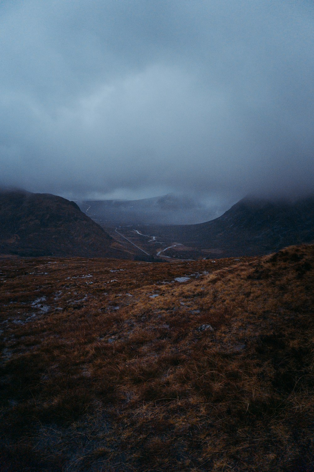 brown and green mountains under white clouds