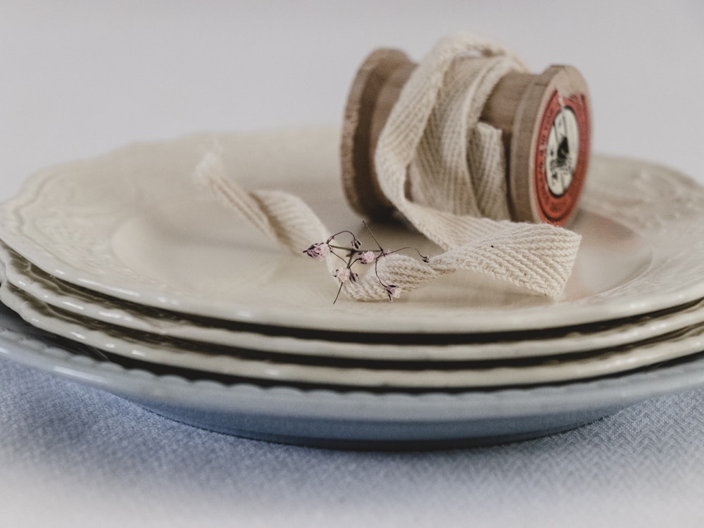 brown and white round ceramic plate with brown rope