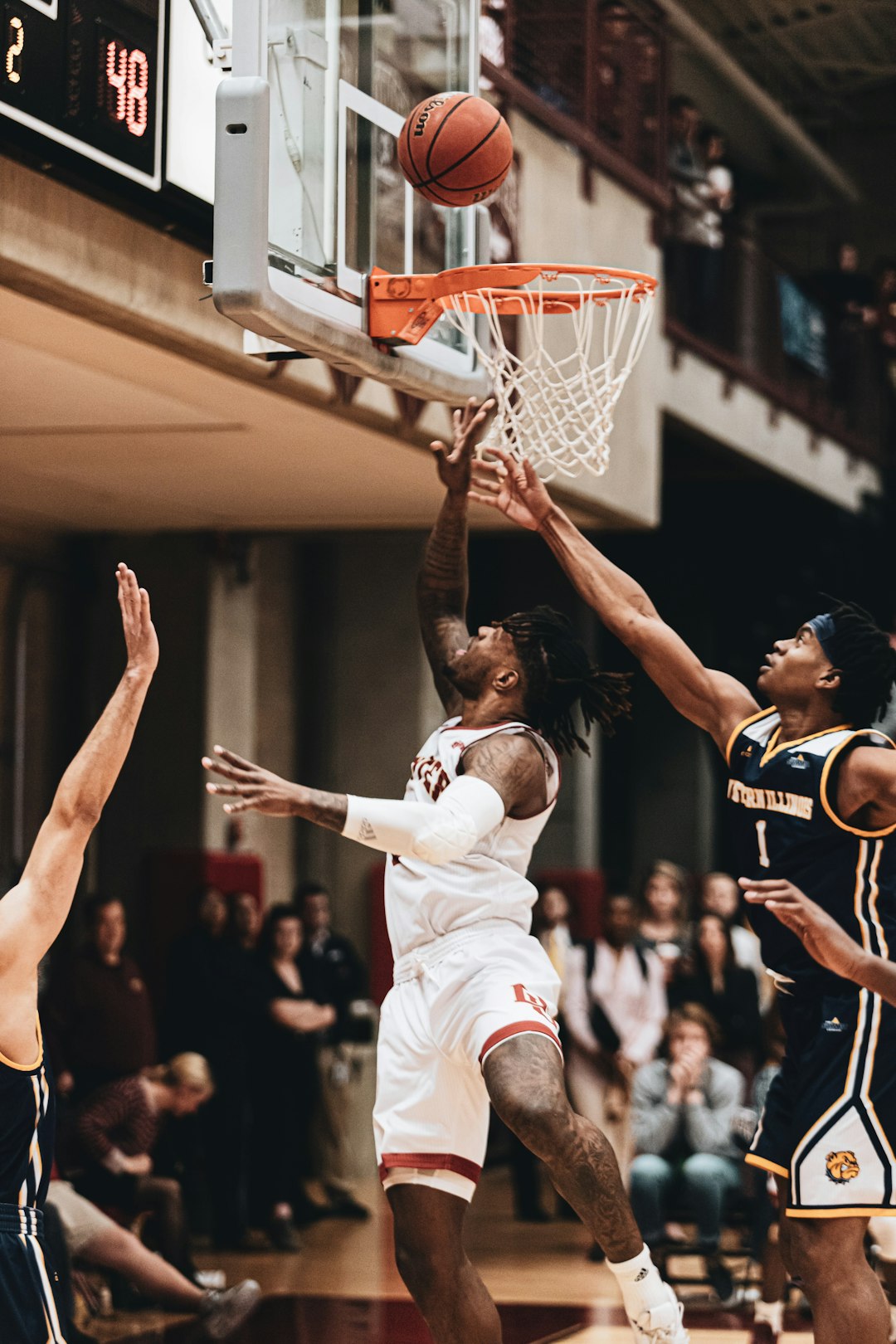 man in white jersey shirt playing basketball