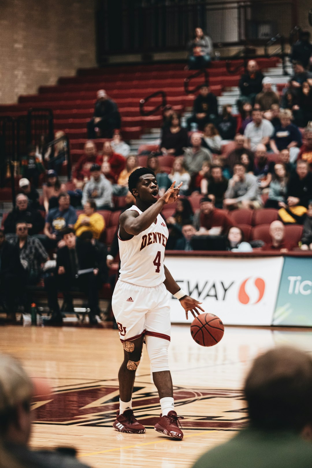 man in white jersey shirt playing basketball