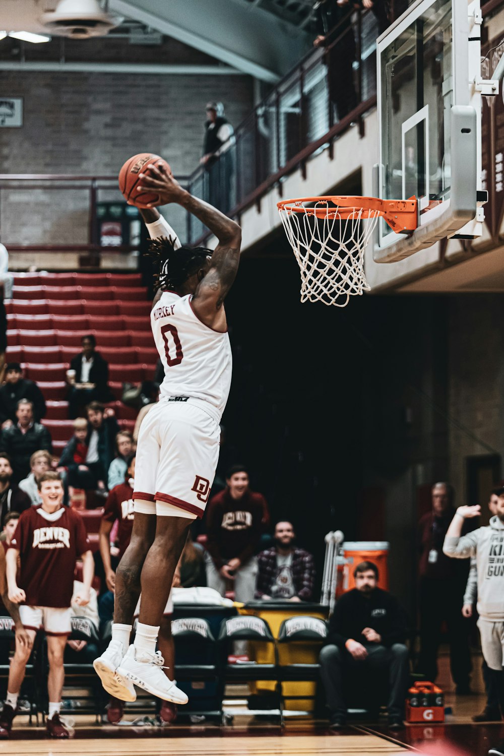 man in white jersey shirt playing basketball