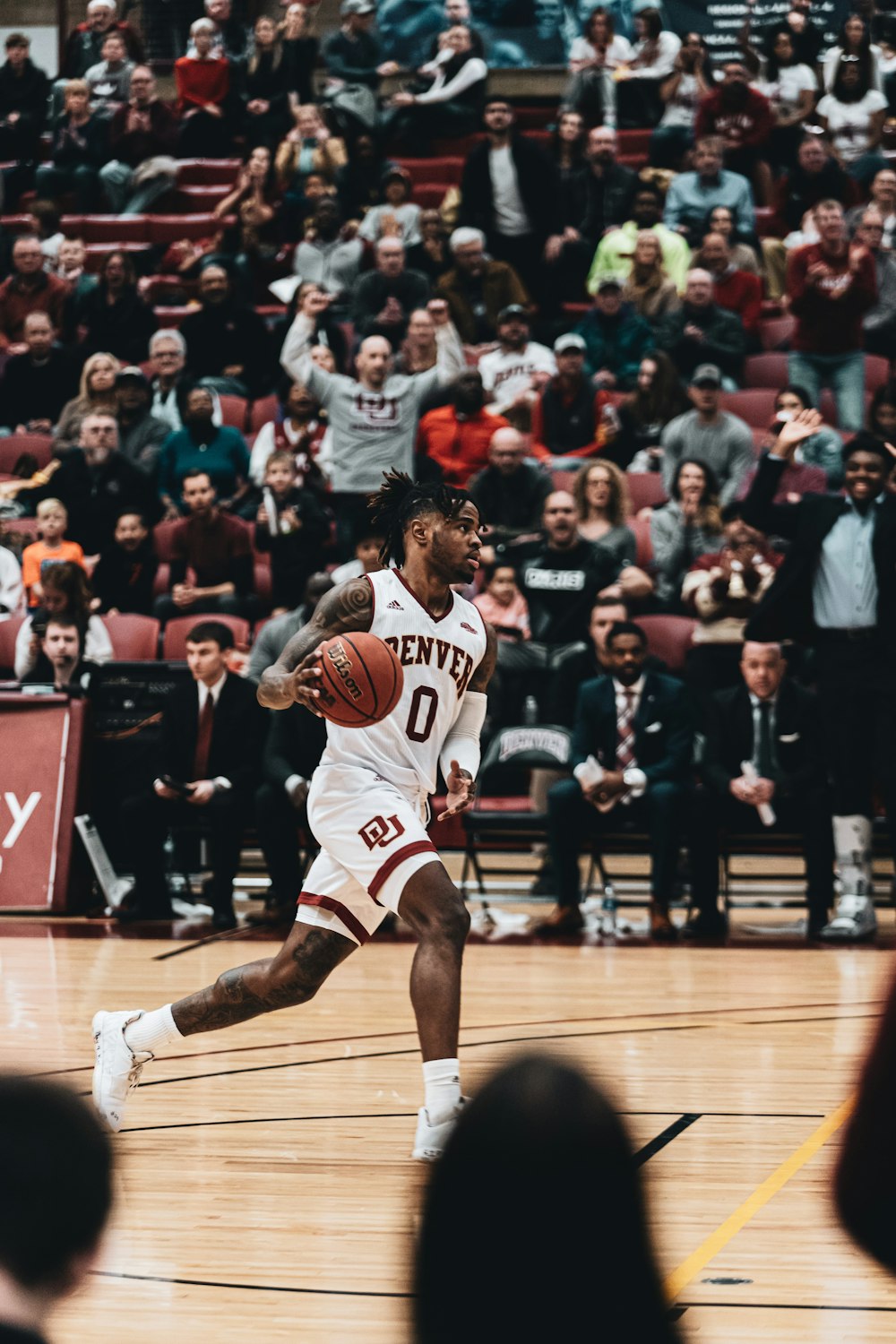 man in red and white jersey shirt playing basketball