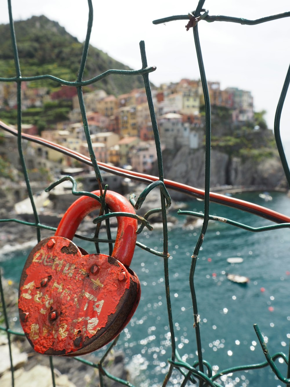 red padlock on black metal fence