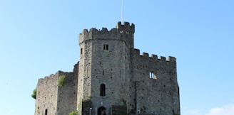 rock castle with flag of wales a during daytime