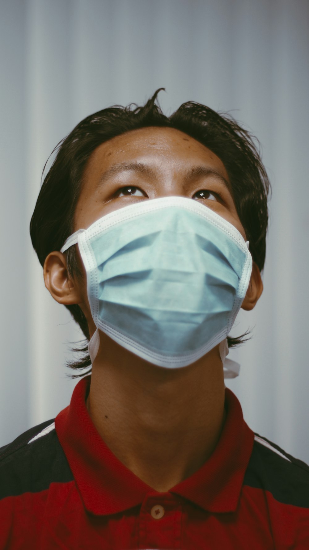 woman in red shirt wearing white face mask