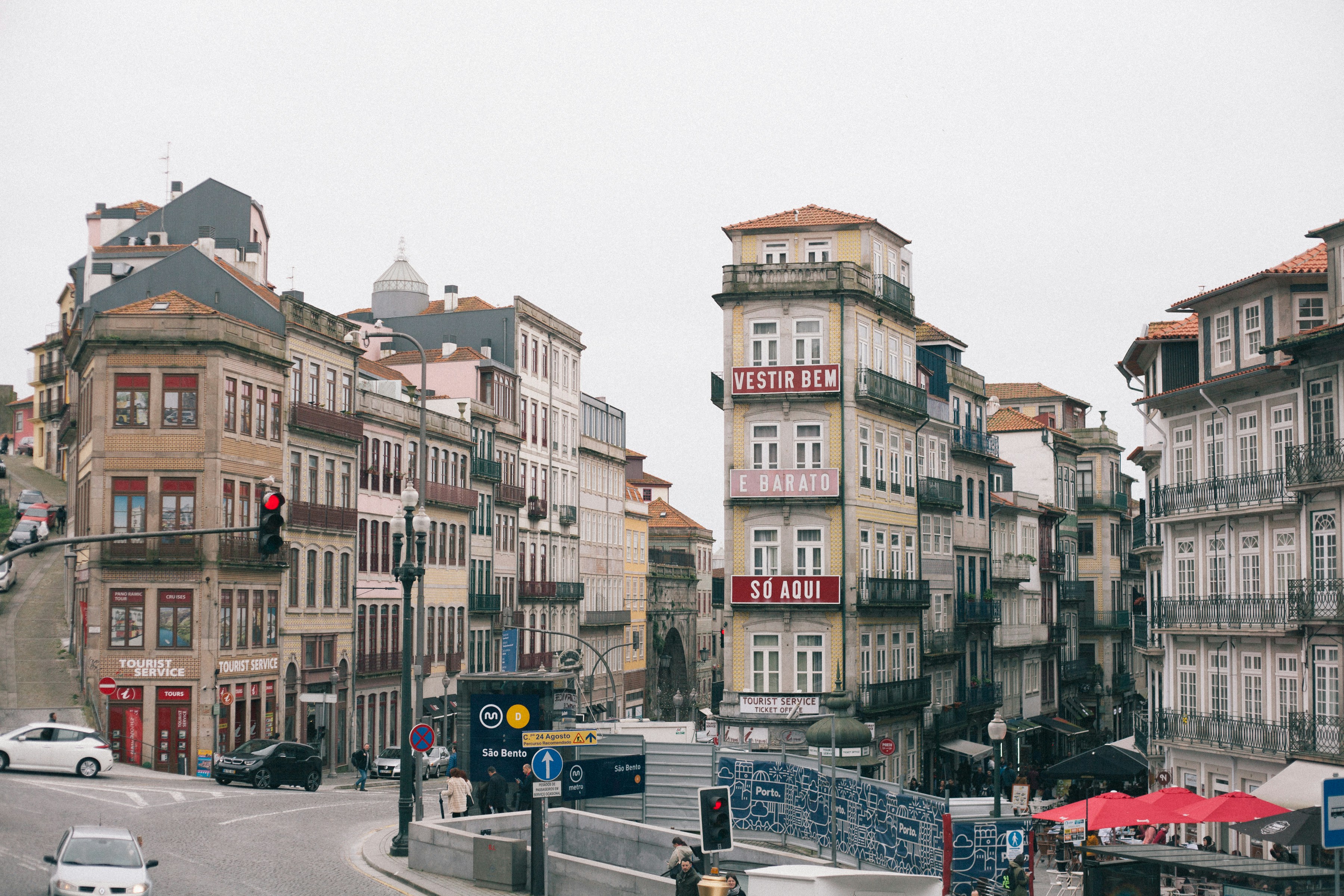 cars parked beside brown concrete building during daytime