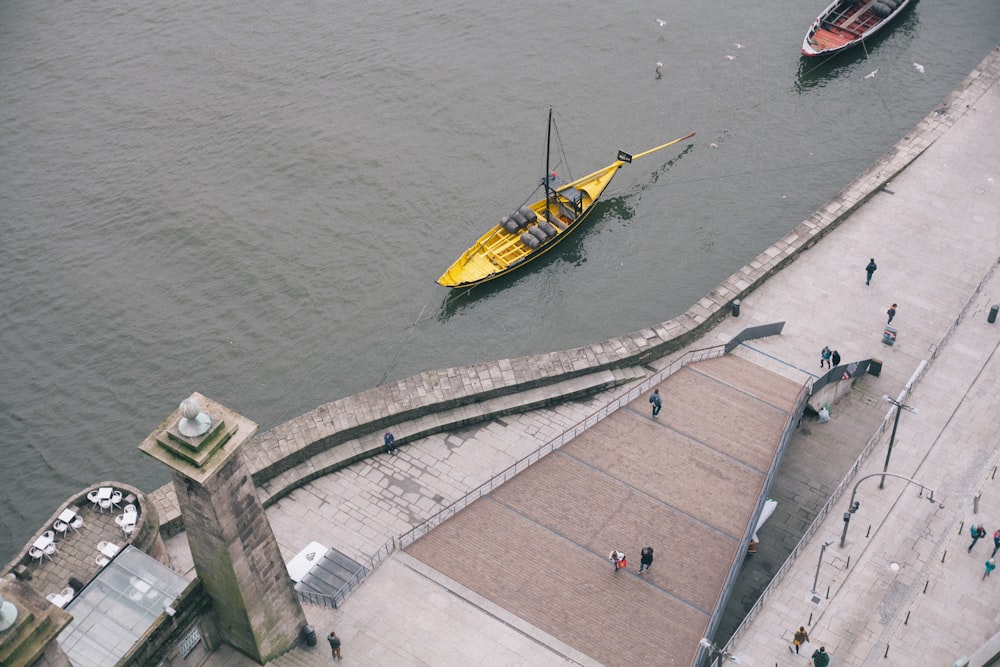 yellow and black boat on body of water during daytime