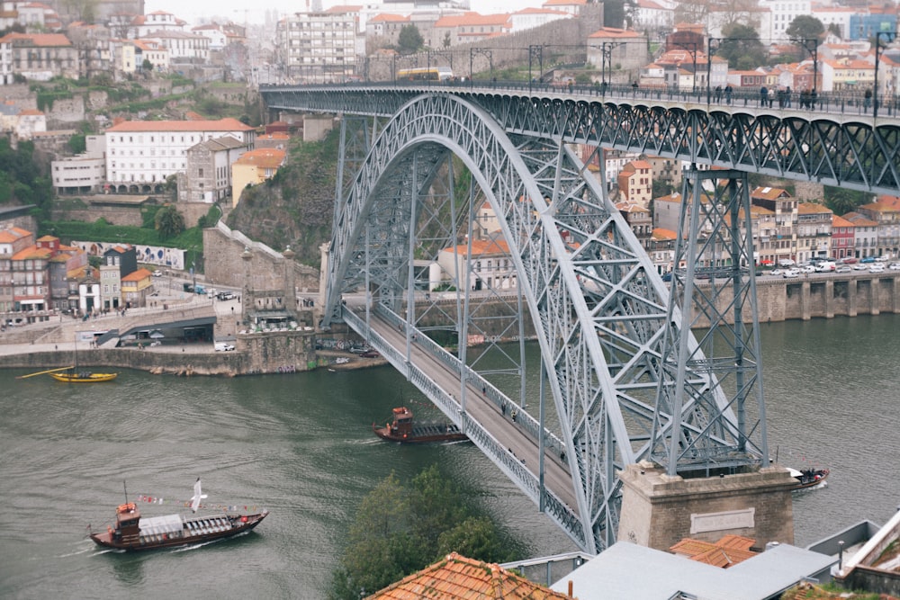 white and red boat on river under bridge during daytime