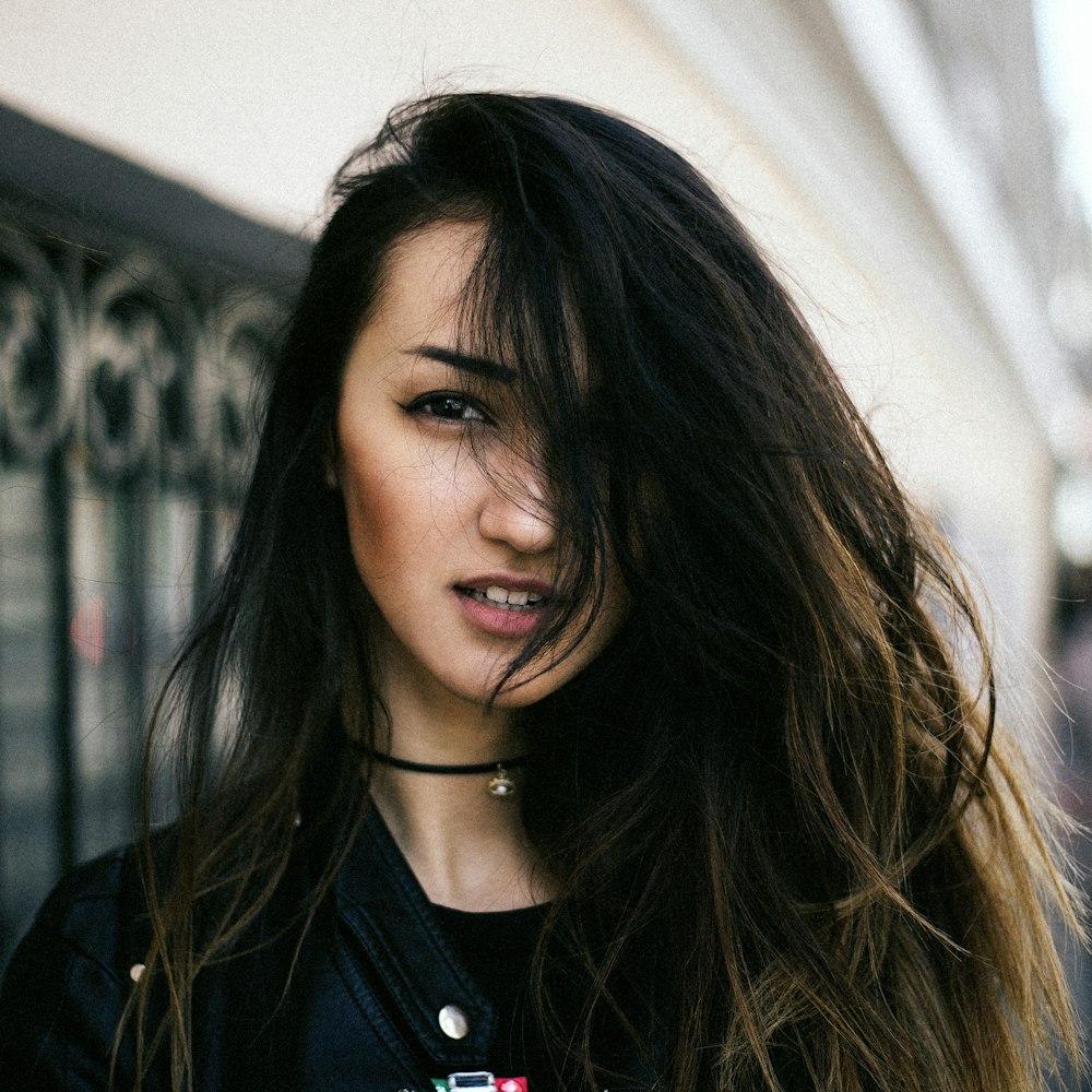 woman in black zip up jacket smiling