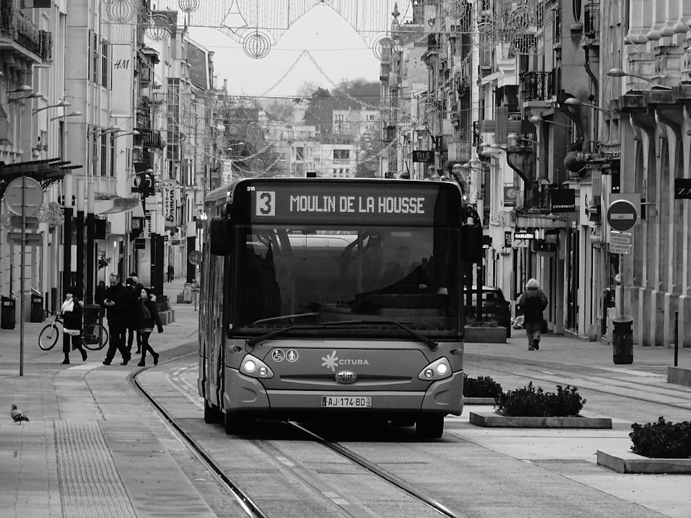 grayscale photo of bus on road