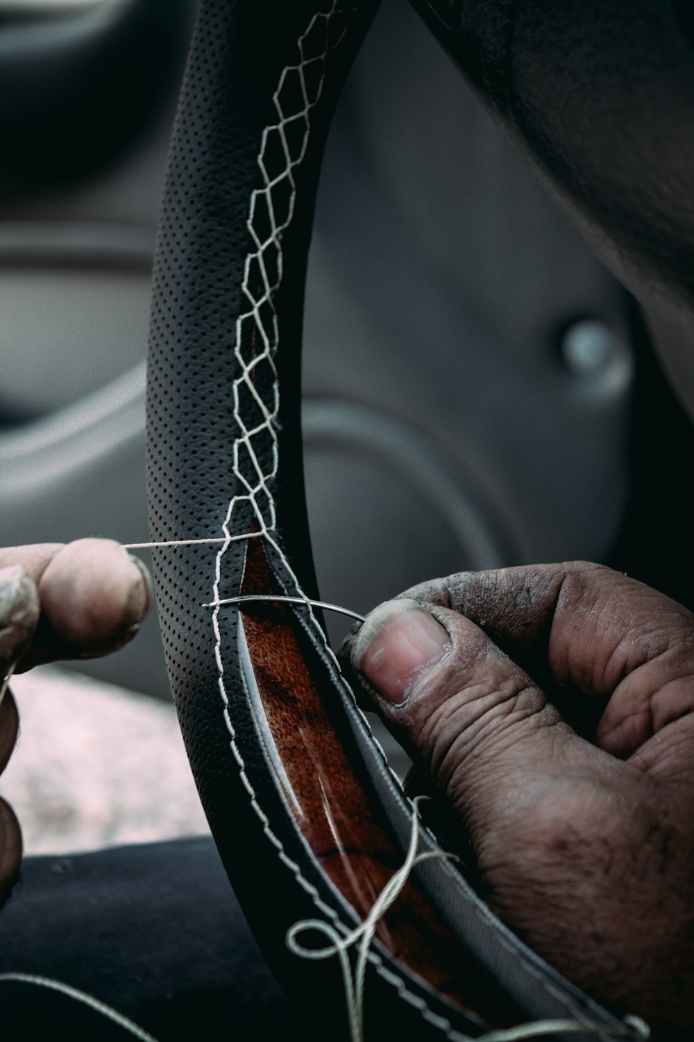 person holding black and brown leather belt