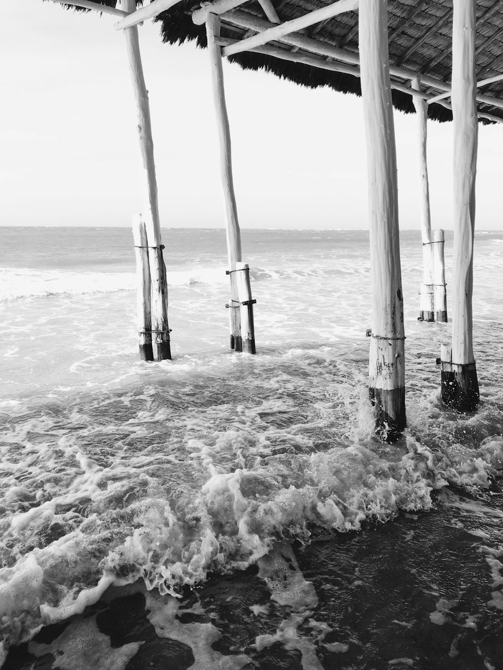 grayscale photo of sea waves crashing on shore