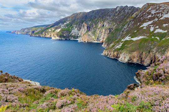 green and brown mountain beside body of water during daytime in Slieve League Ireland