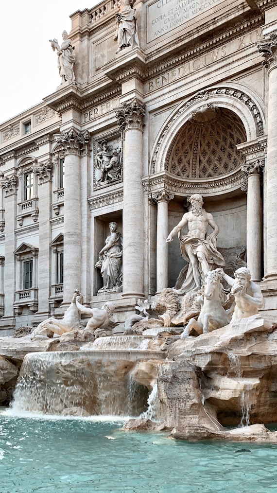 gray concrete statue fountain in front of building