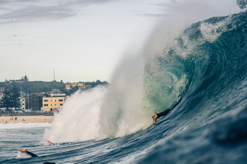 man surfing on sea waves during daytime