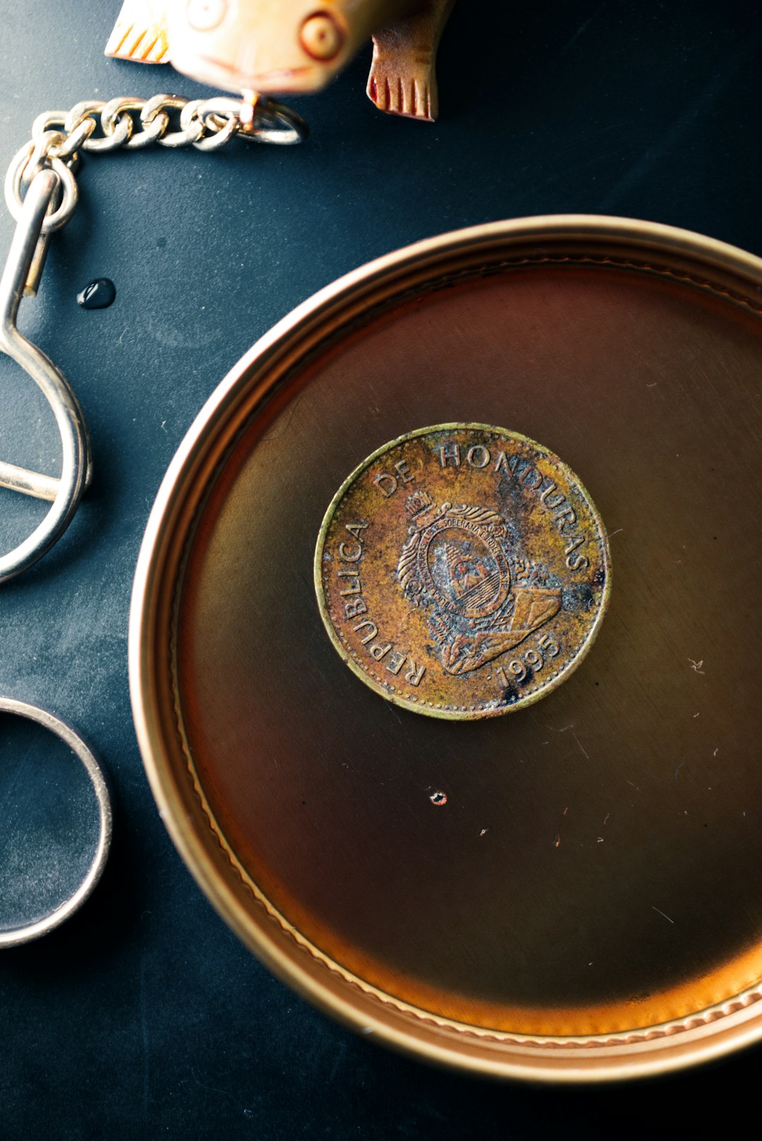 gold round coin on black textile