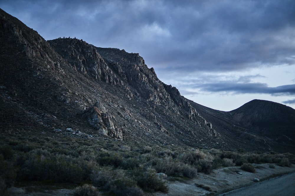 green and brown mountain under white clouds during daytime