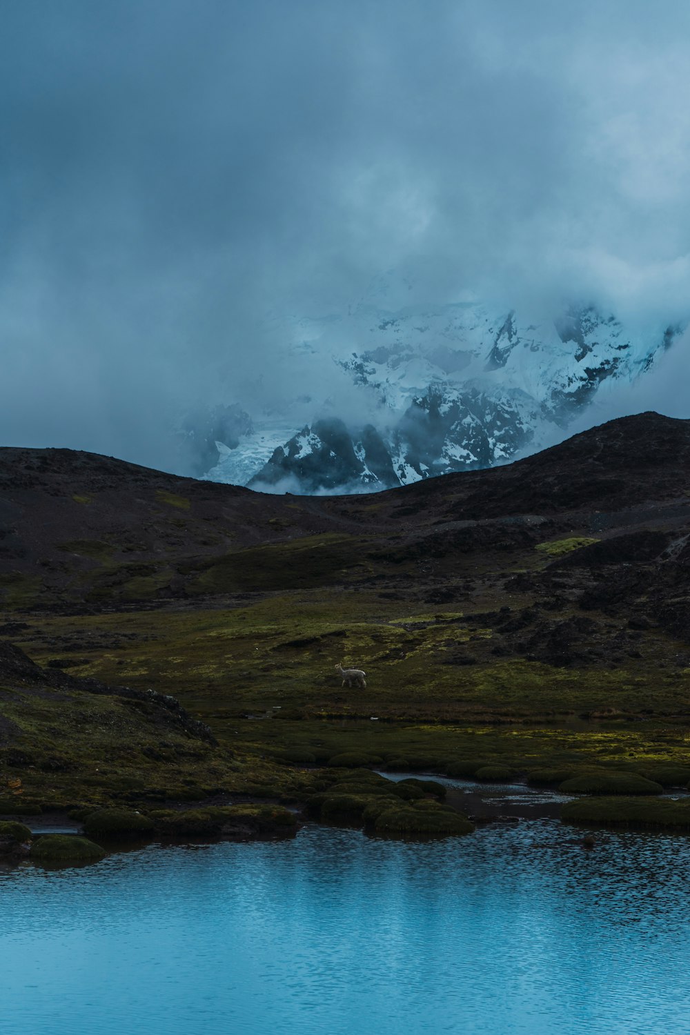 snow covered mountain under cloudy sky during daytime