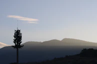 A panoramic view of a Montana ham radio setup with mountains and pine trees surrounding the site.