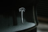 black and gray tesla logo