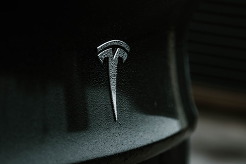 black and gray tesla logo