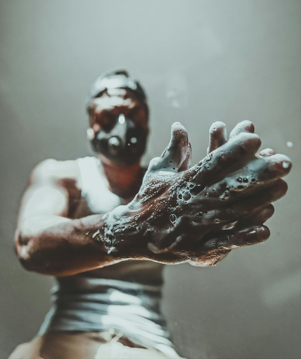 person in white and black stripe shirt with white powder on face