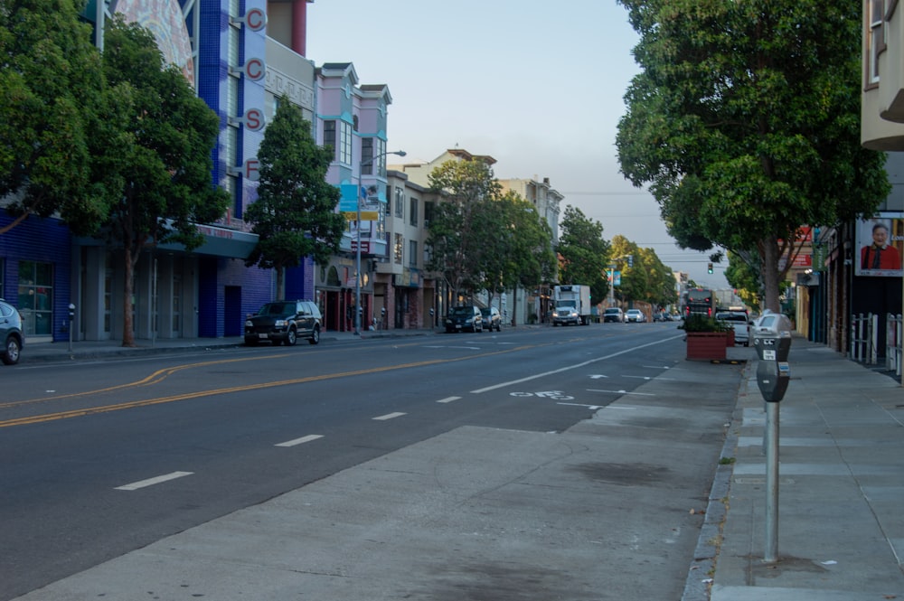 cars parked on sidewalk near buildings during daytime