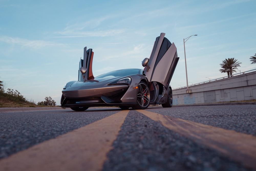 blue and black sports car on road during daytime