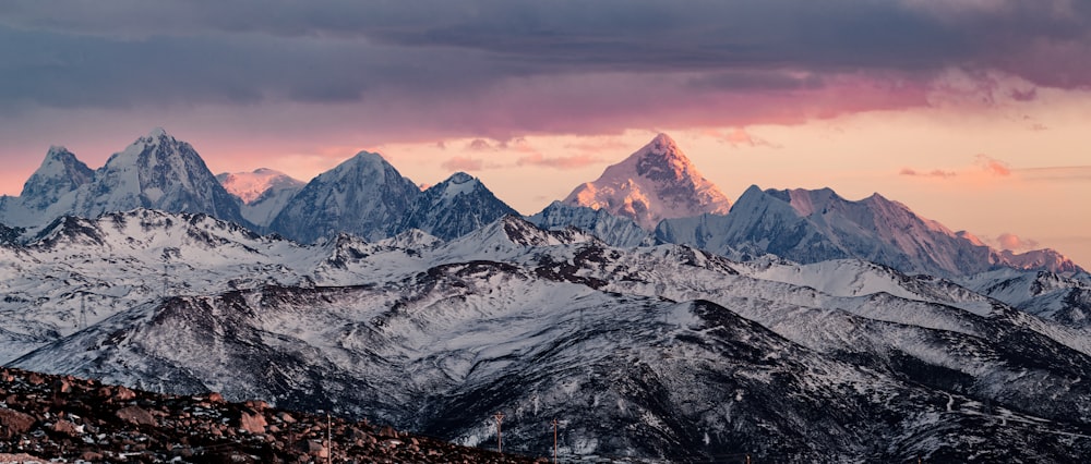 snow covered mountain during sunset