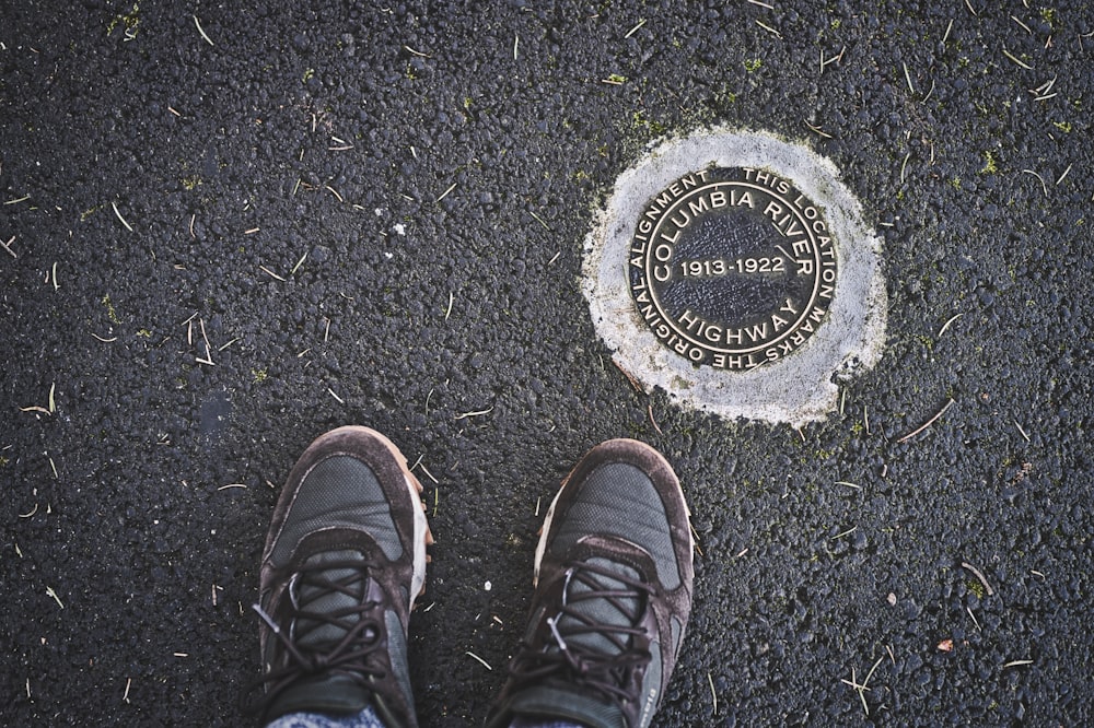 person wearing black leather hiking shoes