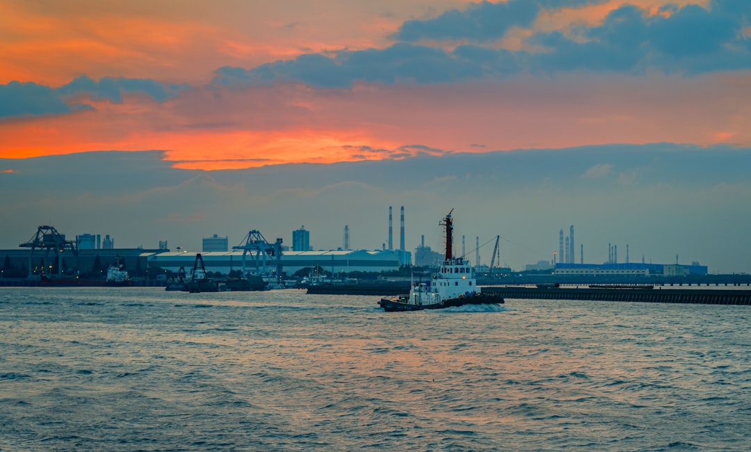 white and black ship on sea during sunset